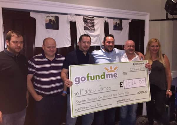 Ian Spedding from Burnley (second right) presents Mathew James (centre right) with a cheque after a fund-raising bid was launched following the Tunisia terrorist attack. (S)