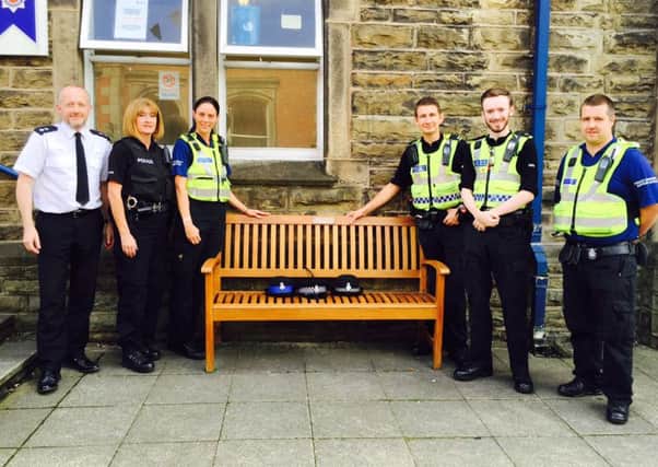 Staff from Clitheroe Police Station with the bench bought in memory of Cate Sutcliffe, who collapsed on duty 11 years ago. (s)