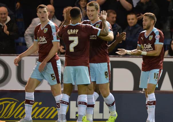 Sam Vokes is congratulated on scoring Burnley's opening goal against the MK Dons