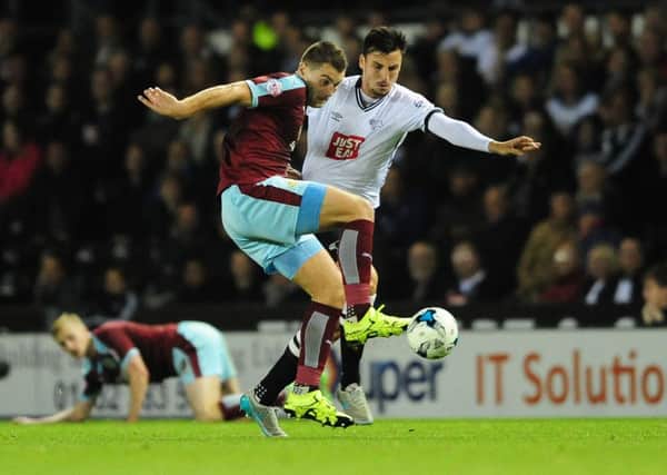 Sam Vokes vies for possession with Derby County's George Thorne