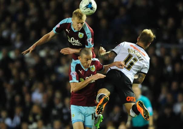 Ben Mee out-jumps Derby County's Johnny Russell