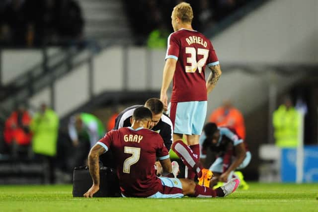 Record signing Andre Gray limped off the pitch against Derby County