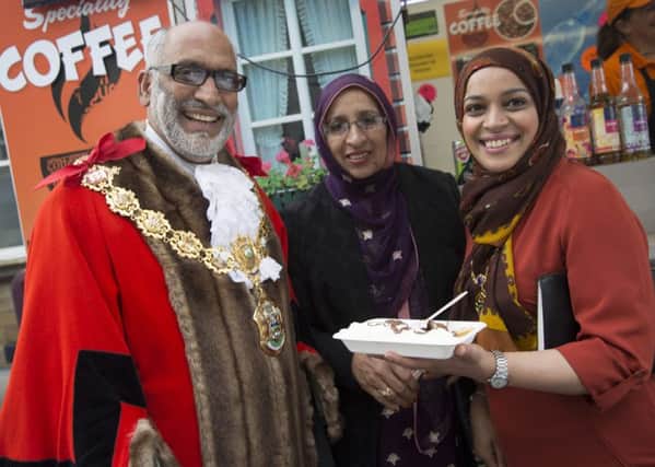 Mayor of Pendle Coun. Nawaz Ahmed and Mayoresses - his wife Azmat and their daughter Uzma - at one of the Worldwide Food Market stalls. (S)