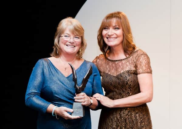 Pat Rogers receives her Inspirational Woman of the Year Award from TV host Lorraine Kelly. Photo: Megan Taylor (s)