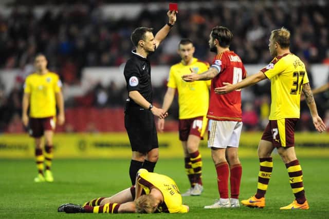 Nottingham Forest's Henri Lansbury is shown a red card by Referee Stuart Attwell for a foul on Ben Mee