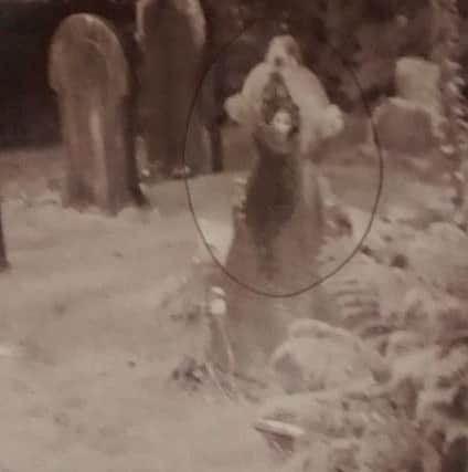 Picture of a woman's face on a gravestone (s)