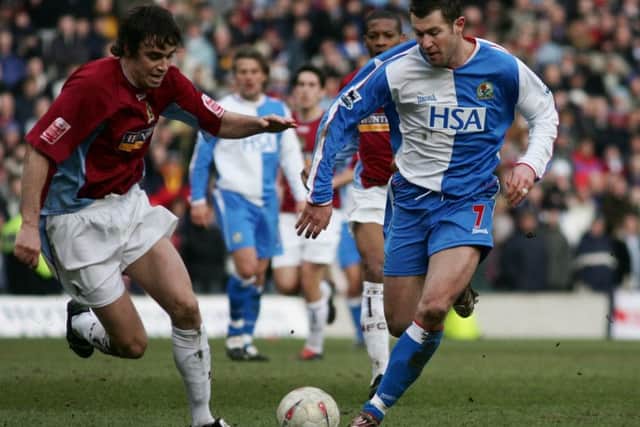 Michael Duff challenges Brett Emerton in his first experience of the derby