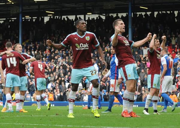 The Burnley players celebrate at the final whistle