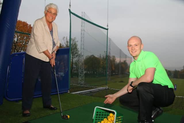 Coun. Bea Foster with golf pro Sam Reeves on the driving range at the new Prairie Sports Village.