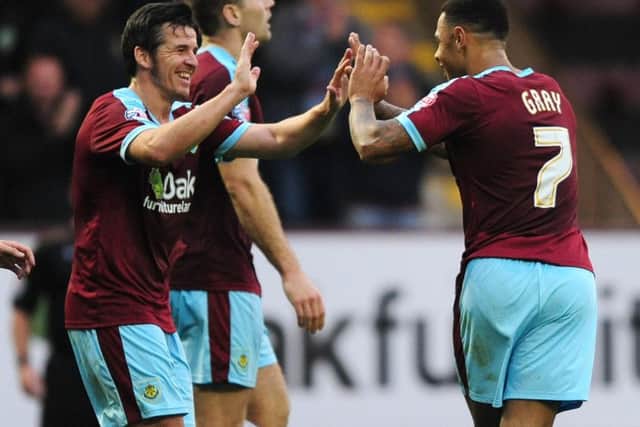Andre Gray celebrates his second with Joey Barton