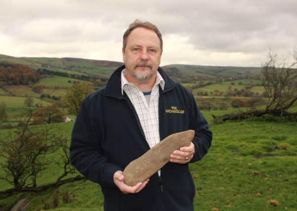 John Clayton with the historic stonework he found