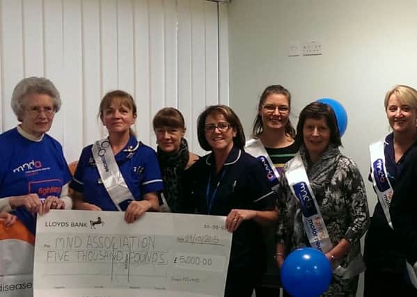 Colne district nurses present their cheque to Maddie Parkinson and Judith Schmuhl of the MND association (S)