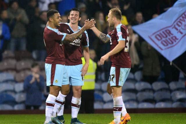 Andre Gray celebrates scoring the second goal with team mates Scott Arfield and Joey Barton