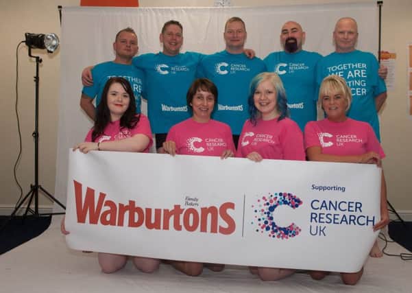 Warbutrons staff members who took part in a charity calendar shoot for Cancer Research UK.