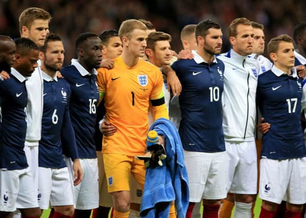 England players stand side by side with their French counterparts before the international friendly match at Wembley Stadium, London. Photo: Nick Potts/PA Wire.