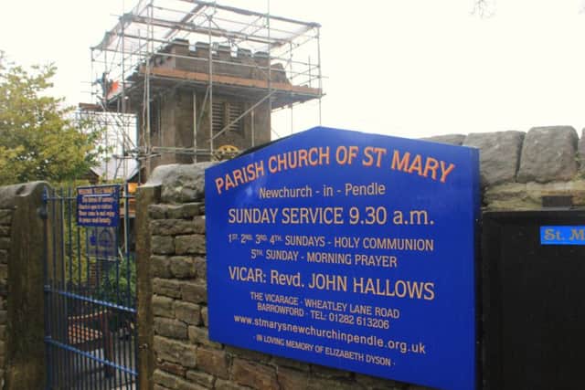 The sign on the entrance to St Mary's, with the tower roof work going on behind.