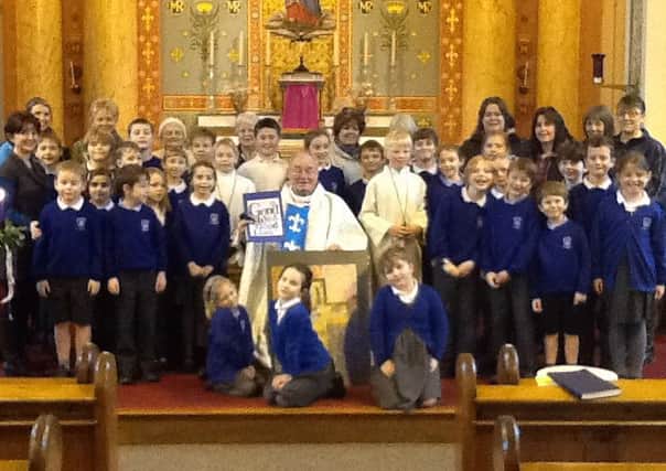 Father Grimsahw surrounded by pupils, staff and parishioners at Sr Mary's Church, Chipping, as they said farwell to him