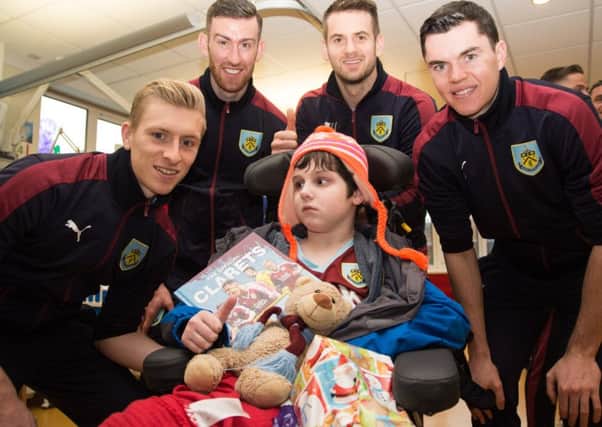Luke Mason (14) receives gifts from Ben Mee, David Jones, Tom Heaton and Michael Keane