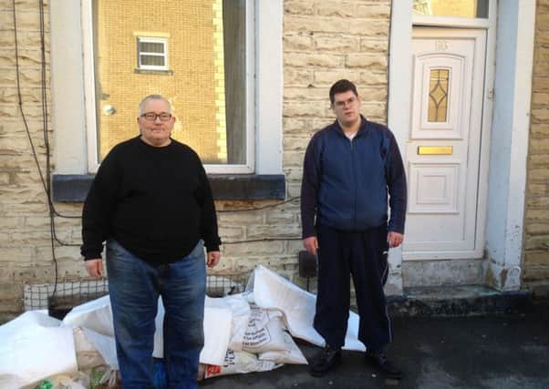 Joe and Jim Charleson outside their flood damaged home in Station Road, Padiham