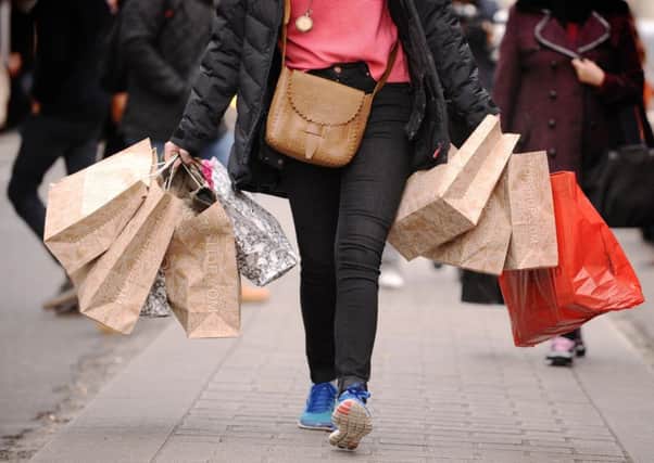 Shopper carrying shopping bags. Photo: Dominic Lipinski/PA Wire