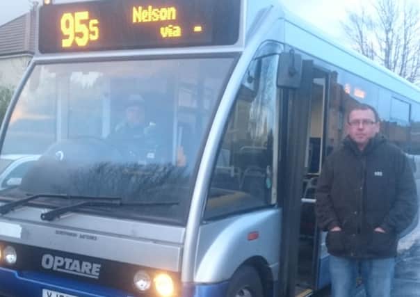 Mark Hartley next to a No. 95 bus. (S)