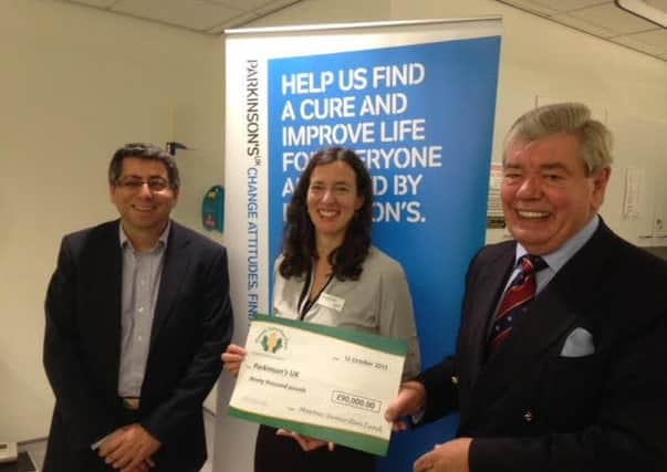 Sir David Trippier (right), head of East Lancashire Freemasons, presents a cheque for Â£90,000 to Teresa Forgione, head of philanthropy at Parkinsons UK, with Prof Shaheen Hamdy (left) (s)