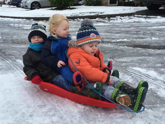 Finlay and Teddy Harding with Sam Noblett playing in the snow for the first time