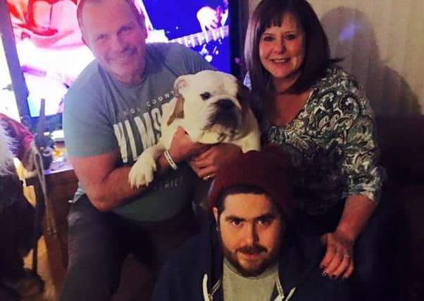 Ben King with mum and dad Fiona and Dave and the family's pet bulldog Bubba. (S)