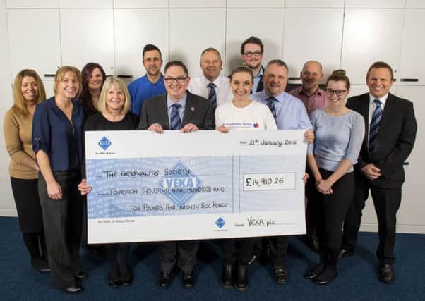 Mark Barsby and the VEKA UK team hand the cheque over to Cassie Meegan-Vickers from the Encephalitis Society (s).