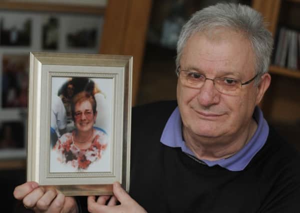 Alan Friel holds a photograph of his wife, Veronica, who died in December, but donated her organs