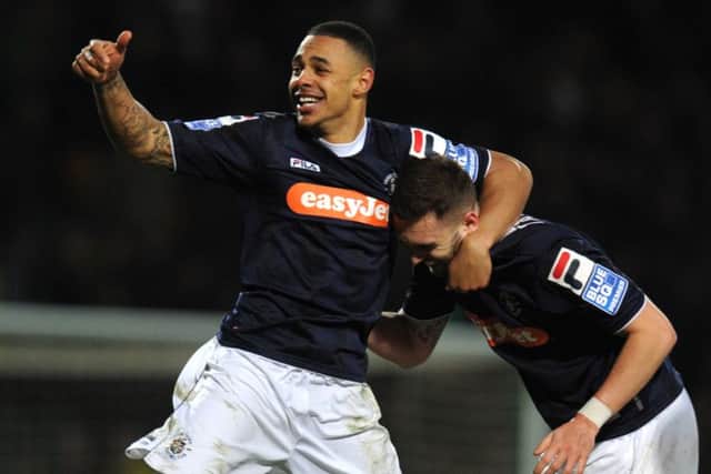 Andre Gray, then at Luton Town, celebrates at the final whistle with Greg Taylor after knocking Norwich City out of the FA Cup Fourth Round match at Carrow Road in 2013