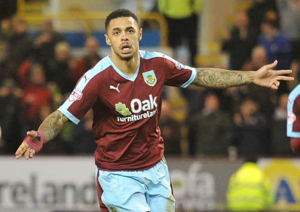 Andre Gray turns to celebrate after putting the Clarets back in front from the penalty spot against Derby