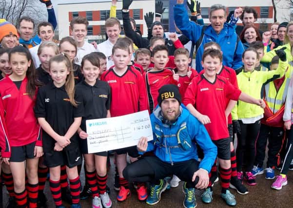 Pupils from Shuttleworthy College and St Leonard's Primary School in Padiham join runner Ben Smith (s)
