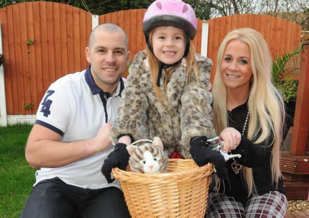 Television star Jolie Forrest with her parents Adam and Jodie on her bike that she rode in the advert for Three Mobile