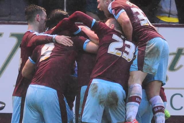 The Burnley players celebrate with goalscorer Sam Vokes