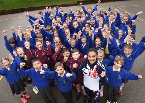 Team GB Athlete Leah Barrow (front) joins Pupils from St John's Church of England Primary School in Cliviger, and Pupils from Holy Trinity CE Primary School, at the launch
the Run a Mile Pilot Scheme. (s)