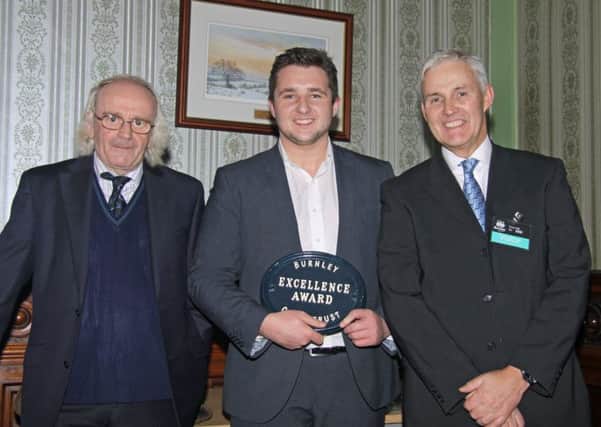 Roger Frost, chairman of Burnley Civic Trust, presents an excellence award to Harrison Kiely, director of Berkshire Homes, with Chris Bailey , site manager (s)
