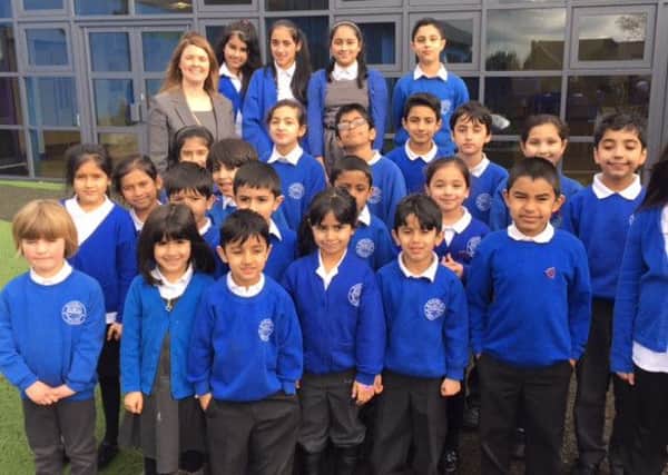 New head teacher Sarah Bell with her pupils at Reedley Primary School IS)