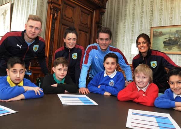 Staff from Burnley FC Sport in the Community, from left, Sam Howell, Rebecca Robertson, Matt Pounder and Abby Illard, talk to children who form the Pupil's Parliament, about opportunities and education, at Burnley Town Hall.