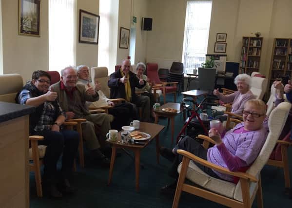 Residents at Crow Wood Court in Burnley and Coun. Gordon Birtwistle celebrate after lifeline bus services were saved (s)