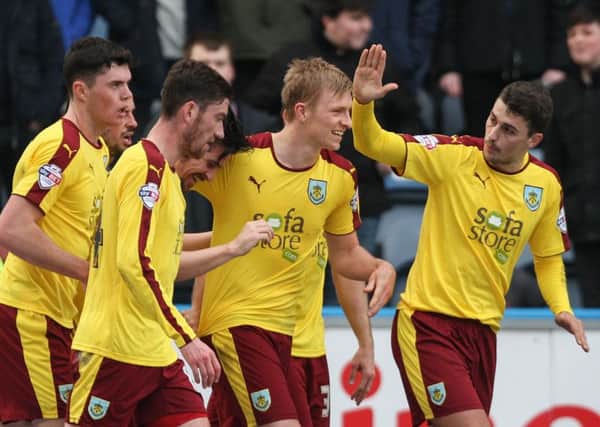Burnleys Ben Mee, centre, celebrates with teammates after scoring his sides third goal