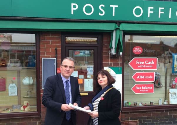 Post Office regional public affairs manager Mr Richard Hall receives a petition from Burnley MP Julie Cooper (s)