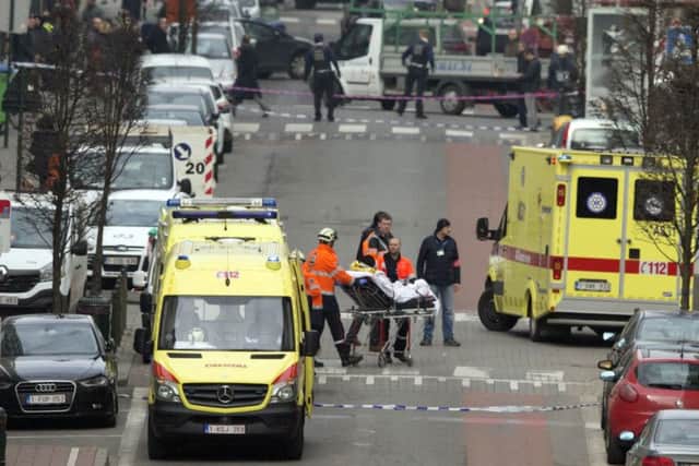 A victim is evacuated on a stretcher by emergency services after a explosion in a main metro station in Brussels
