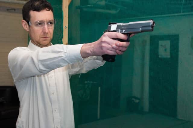 TOP GUN: Express reporter Dominic Collis takes aim (Note: gun unloaded)