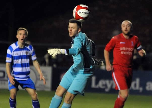 Action from the Lancashire FA Challenge Trophy semi-final between Lancaster City (blue and white) v Padiham, at the County Ground in Leyland.
Padiham keeper Mike Donlon turns a shot away.  PIC BY ROB LOCK
23-2-2016