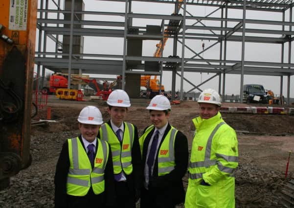 Leighton Burgoyne, Jacob Wilson and Jason Beaumont inspect the building work with site manager Mark Prince. (s)