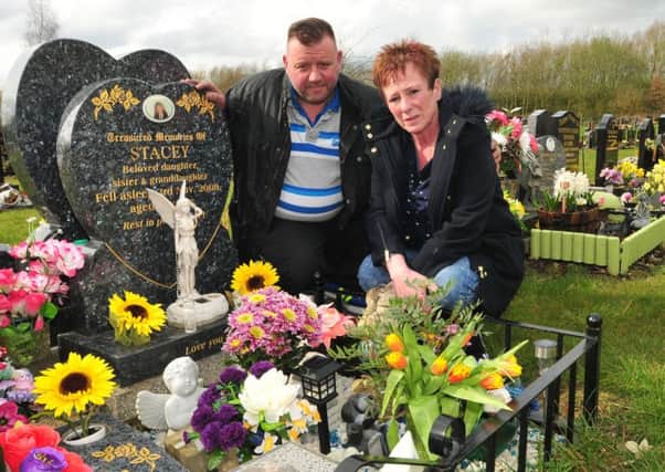 Wayne and Julie Roberts by the side of their daughter Stacey's grave in Howe Bridge Cemetary
