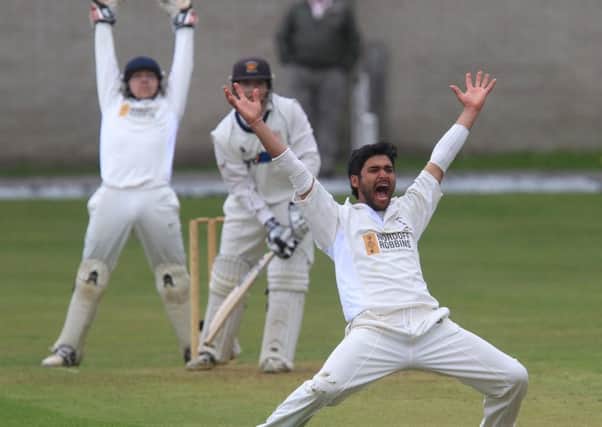 Burnley captain Bharat Tripathi and wicket-keeper Chris Burton appeal in vain for a lbw decision in the game against Lowerhouse.