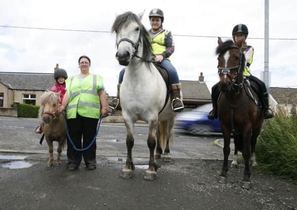 oann Pollock says that drivers have no idea how to act when passing horses on the road. She is pictured with Lucy Corroon on Halle; Lauren Hamilton on Merlin and Sophie Corroon on Coco