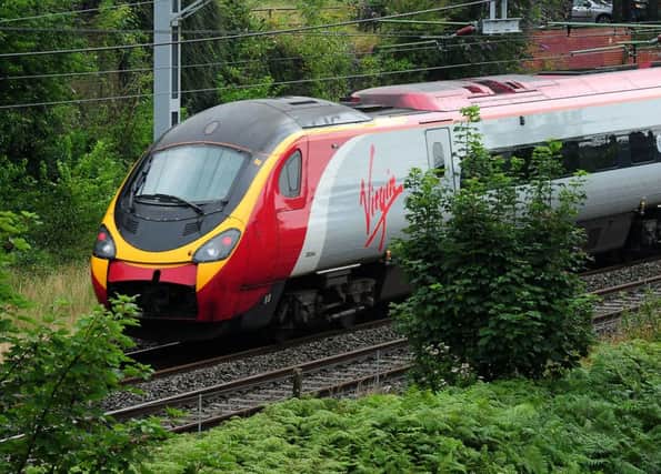File photo dated 15/8/2012 of a Virgin train, as Virgin Trains today promised to increase capacity on the West Coast mainline after it secured a deal to continue running the franchise until March 2017. PRESS ASSOCIATION Photo. Issue date: Thursday June 19, 2014. The operator said there will be "significant improvements" for customers with the introduction of free superfast WiFi, more seats and new services. See PA story CITY Virgin. Photo credit should read: Rui Vieira/PA Wire